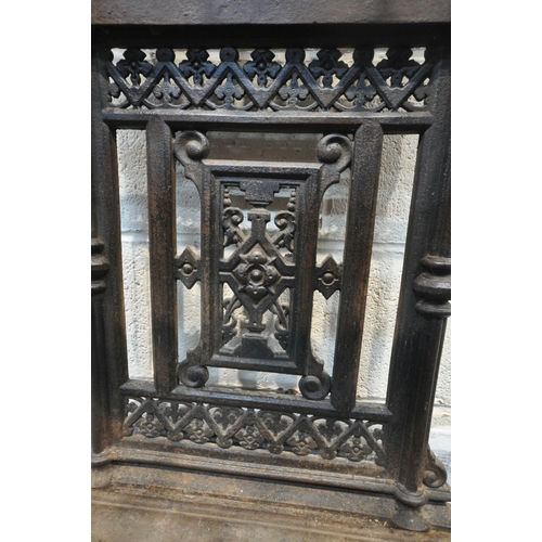 1329 - A VICTORIAN CAST IRON HALL STAND, with an arrangement of rails and pegs, a small circular mirror, re... 