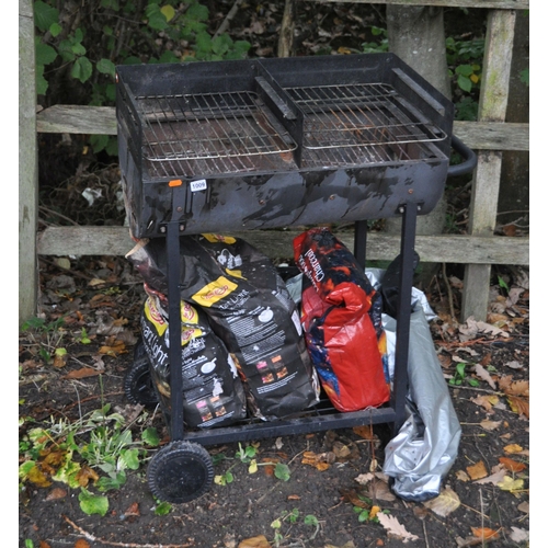 1009 - A MODERN CAST IRON CHIMINEA, height 122cm, along with a barbeque, coals and cover. (5)