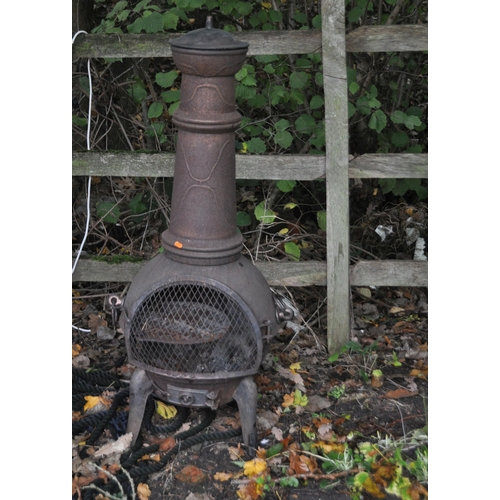 1009 - A MODERN CAST IRON CHIMINEA, height 122cm, along with a barbeque, coals and cover. (5)