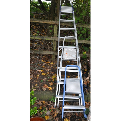 1010 - TWO ALUMINIUM AND ONE STEEL STEP LADDERS the largest being 229cm high (3)