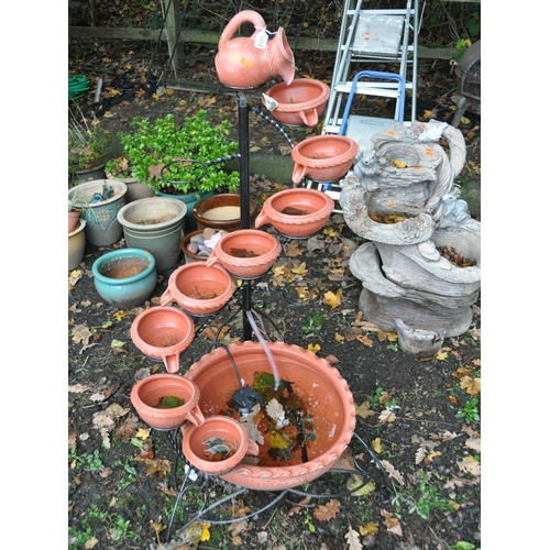 1012 - A MODERN WROUGHT IRON AND EARTHENWARE GARDEN WATER FEATURE in the form of a series of jug and bowls ... 