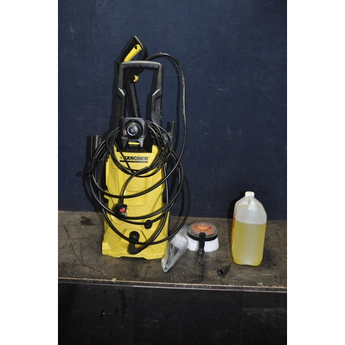 1058 - A KARCHER K4 PRESSURE WASHER with lance, spare nozzle, two brushes, patio head and cleaning fluid (P... 