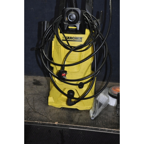 1058 - A KARCHER K4 PRESSURE WASHER with lance, spare nozzle, two brushes, patio head and cleaning fluid (P... 