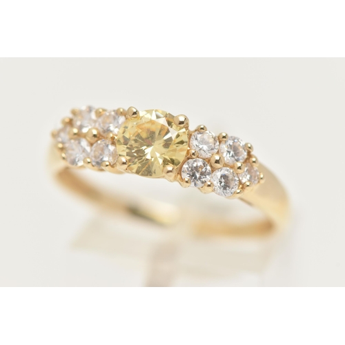 15 - A 14CT GOLD CLUSTER RING, set with a circular cut yellow cubic zirconia and ten circular cut colourl... 