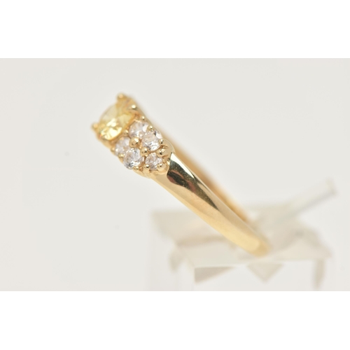 15 - A 14CT GOLD CLUSTER RING, set with a circular cut yellow cubic zirconia and ten circular cut colourl... 