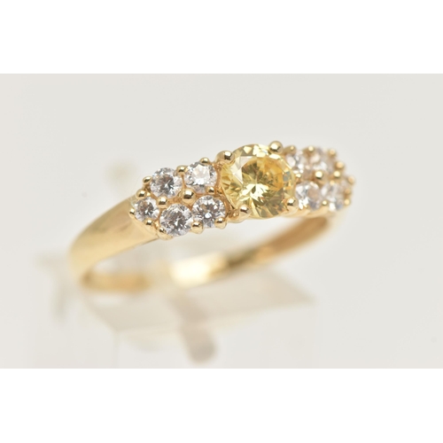 15 - A 14CT GOLD CLUSTER RING, set with a circular cut yellow cubic zirconia and ten circular cut colourl... 