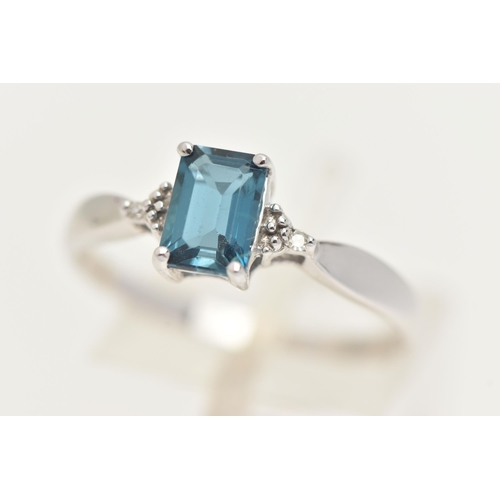 27 - A 9CT GOLD GEM SET RING, a rectangular cut blue topaz, flanked with two single cut diamonds, prong s... 