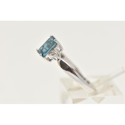 27 - A 9CT GOLD GEM SET RING, a rectangular cut blue topaz, flanked with two single cut diamonds, prong s... 