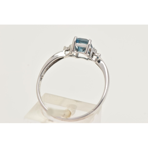 27 - A 9CT GOLD GEM SET RING, a rectangular cut blue topaz, flanked with two single cut diamonds, prong s... 