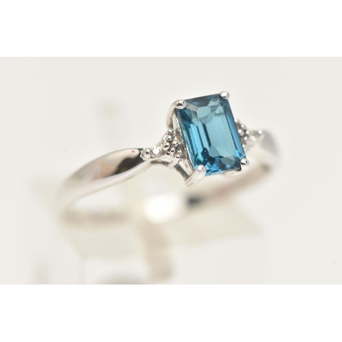 27 - A 9CT GOLD GEM SET RING, a rectangular cut blue topaz, flanked with two single cut diamonds, prong s... 