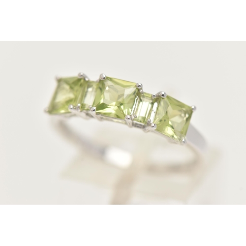 28 - A 9CT GOLD GEM SET RING, three square cut and two rectangular cut green stones, prong set in white g... 