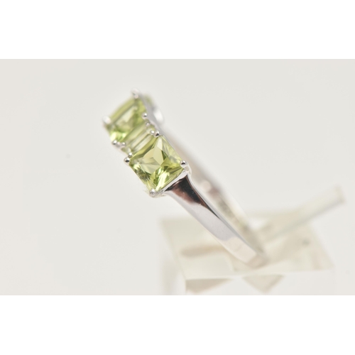 28 - A 9CT GOLD GEM SET RING, three square cut and two rectangular cut green stones, prong set in white g... 