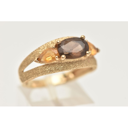 31 - A 9CT GOLD GEM SET RING, an oval cut smoky quartz and two pear cut citrines, prong set in yellow gol... 