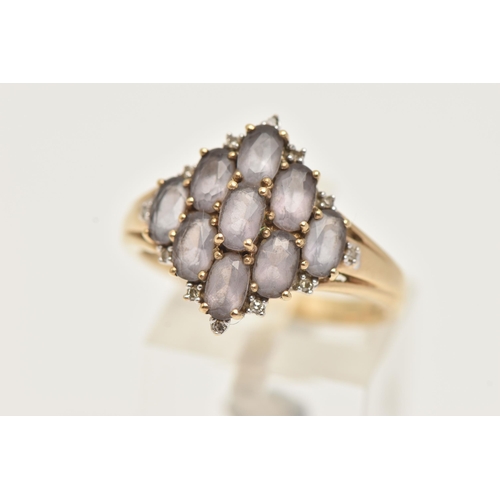 32 - A 9CT GOLD CLUSTER RING, nine oval cut amethyst, prong set with diamond accents, yellow gold shank, ... 