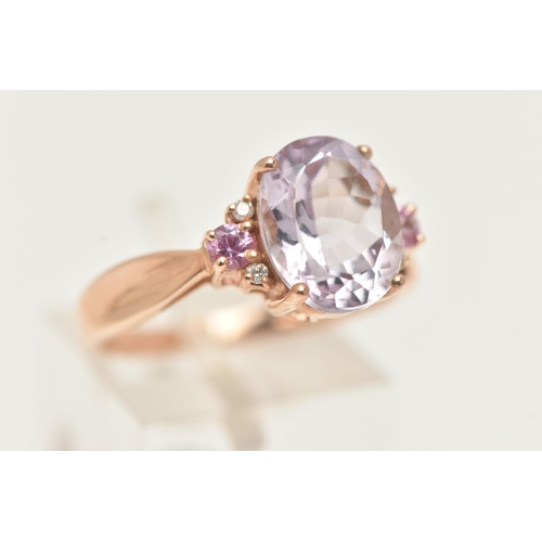 41 - A 9CT GOLD GEM SET RING, an oval cut pink stone, flanked with four round brilliant cut diamonds and ... 