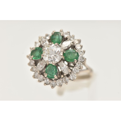 6 - A DIAMOND AND EMERALD CLUSTER RING, a large floral design, principally set with an old cut diamond, ... 