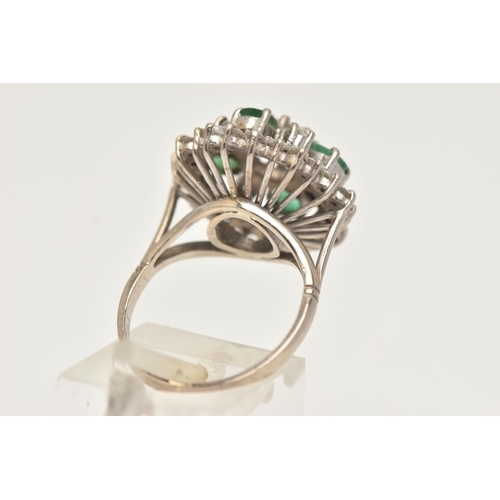 6 - A DIAMOND AND EMERALD CLUSTER RING, a large floral design, principally set with an old cut diamond, ... 