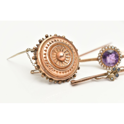 69 - THREE BROOCHES, the first a principally set circular cut amethyst, set with a surround of seed pearl... 