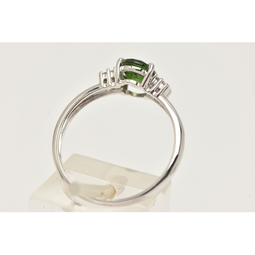 88 - A 9CT GOLD GEM SET RING, an oval cut green stone assessed as tourmaline, flanked with four circular ... 