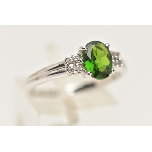 88 - A 9CT GOLD GEM SET RING, an oval cut green stone assessed as tourmaline, flanked with four circular ... 