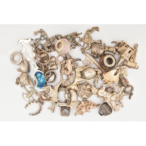 89 - AN ASSORTMENT OF WHITE METAL CHARMS, a various assortment of designs, including horse shoe, animals,... 