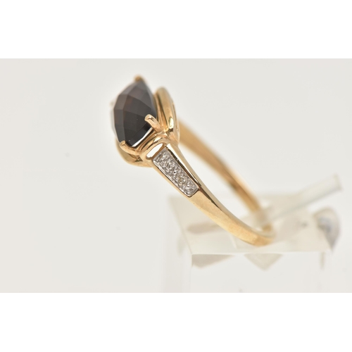 9 - A YELLOW METAL GEM SET RING, a faceted oblong smoky quartz, flanked with four single cut diamonds, y... 