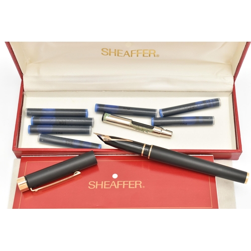 100 - A 'SHEAFFER' FOUNTAIN PEN, a black cased pen signed 'Sheaffer', fitted with a yellow metal nib, stam... 