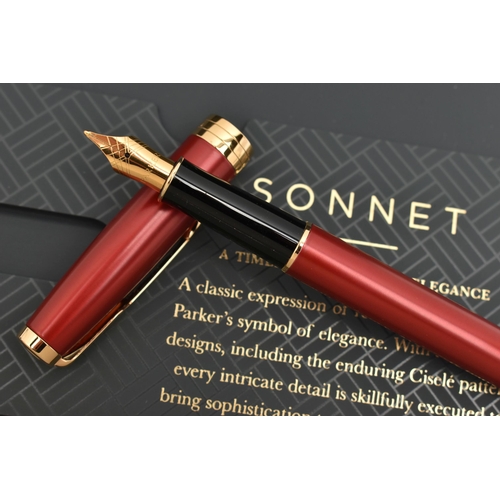 102 - A 'PARKER' SONNET FOUNTAIN PEN, a boxed red fountain pen, signed 'Parker', nib signed 'Parker', (con... 