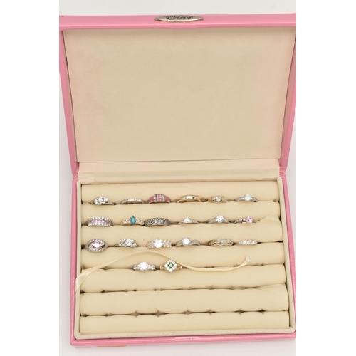 135 - A PINK RING STORAGE BOX WITH TWENTY WHITE METAL RINGS, of various designs, most set with cubic zirco... 