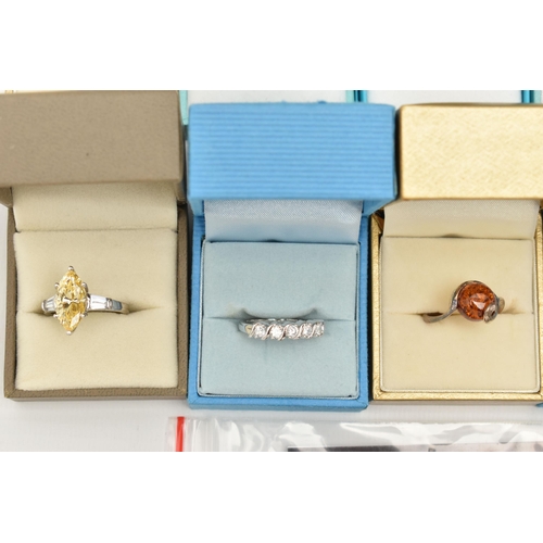 141 - A COLLECTION OF BOXED WHITE METAL RINGS, to include thirteen rings of various designs, some set with... 