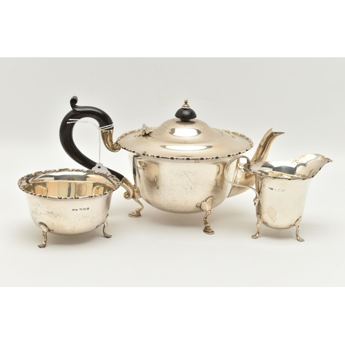 150 - AN EARLY 20TH CENTURY SILVER THREE PIECE TEA SET, comprising of a polished form with wavy rim teapot... 