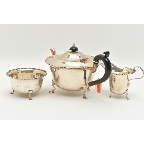 150 - AN EARLY 20TH CENTURY SILVER THREE PIECE TEA SET, comprising of a polished form with wavy rim teapot... 