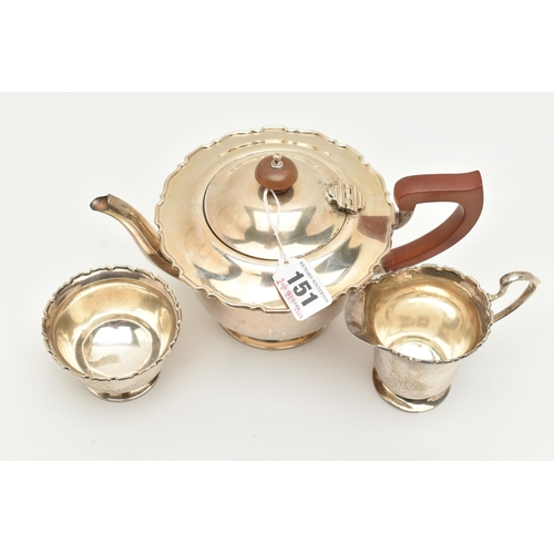 151 - A GEORGE VI SILVER THREE PIECE TEA SET, comprising of a polished form with wavy rim teapot, hinged c... 