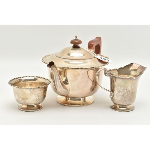 151 - A GEORGE VI SILVER THREE PIECE TEA SET, comprising of a polished form with wavy rim teapot, hinged c... 