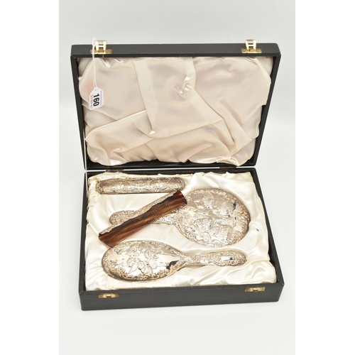 160 - A CASED ELIZABETH II SILVER VANITY SET, embossed cherub and foliate design with vacant cartouche, co... 