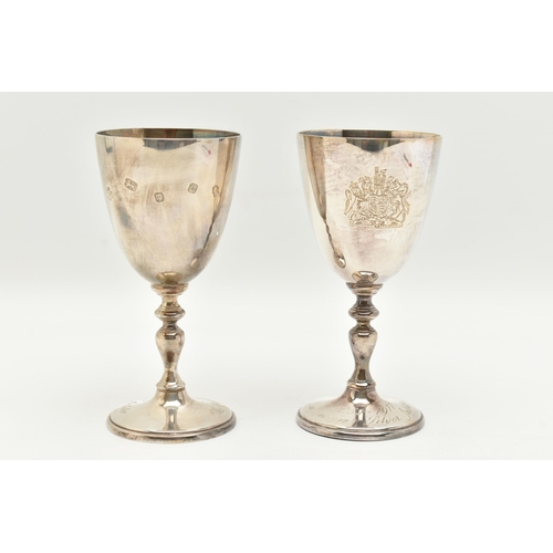 162 - A PAIR OF ELIZABETH II SILVER GOBLETS, engraved with a coats of arms, knopped stem on a round base e... 