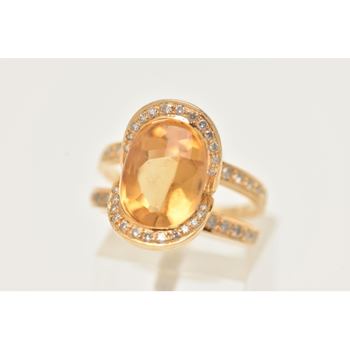 176 - A MODERN YELLOW METAL CITRINE AND DIAMOND DRESS RING, set with an oval shape fancy cut Citrine, meas... 