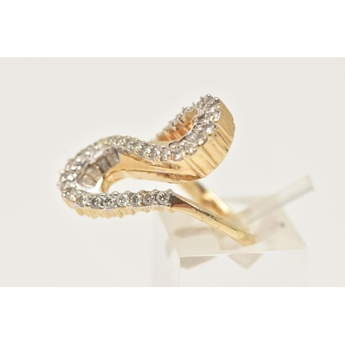 177 - A MODERN DIAMOND DRESS RING, the ring is of an abstract design, set with graduating tapered baguette... 