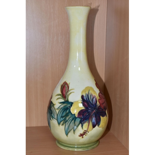 305 - A YELLOW MOORCROFT HIBISCUS PATTERNED BOTTLE VASE with tube lined hibiscus pattern, a Queen Mary lab... 