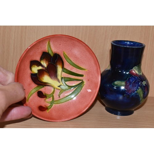 308 - A MOORCROFT FREESIA PLATE AND VASE to include a small red footed glazed trinket dish with a freesia ... 