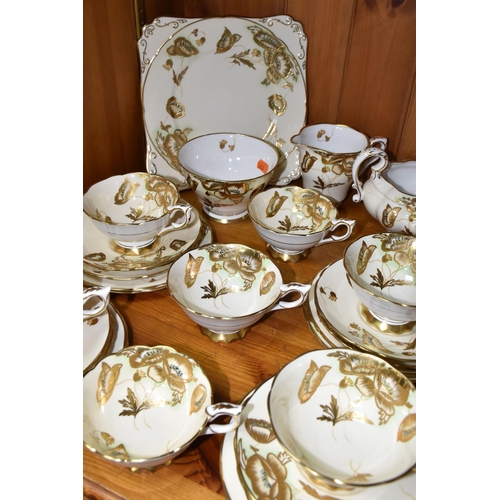 351 - A FORTY TWO PIECE ROYAL STAFFORD TEA SET, decorated with gilt poppies on a cream ground, pattern no ... 