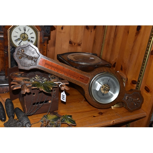 352 - A GROUP OF CLOCKS, comprising a cuckoo clock with weights and pendulum, with cuckoo and guitar playe... 