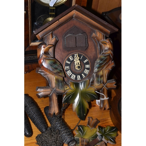 352 - A GROUP OF CLOCKS, comprising a cuckoo clock with weights and pendulum, with cuckoo and guitar playe... 