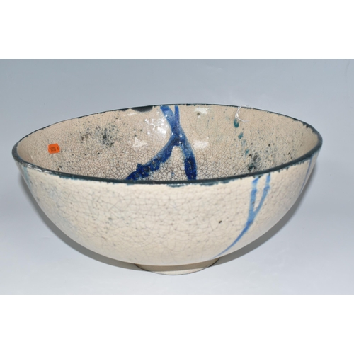 364 - CATRIONA McLEOD: A LARGE RAKU FIRED BOWL, decorated with blue and turquoise bands on a cream crackle... 