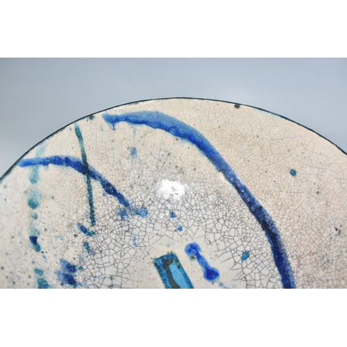 364 - CATRIONA McLEOD: A LARGE RAKU FIRED BOWL, decorated with blue and turquoise bands on a cream crackle... 