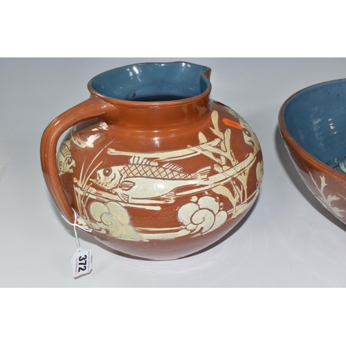 372 - A C.H BRANNAM BARUMWARE JUG AND BOWL comprising a brown sgraffito Barum bowl with glazed blue interi... 