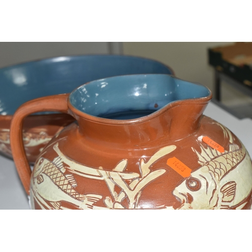 372 - A C.H BRANNAM BARUMWARE JUG AND BOWL comprising a brown sgraffito Barum bowl with glazed blue interi... 