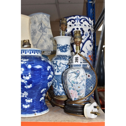 395 - A COLLECTION OF TALL ITEMS AND LAMPS, to include a small oriental blue ceramic table lamp, pattern b... 