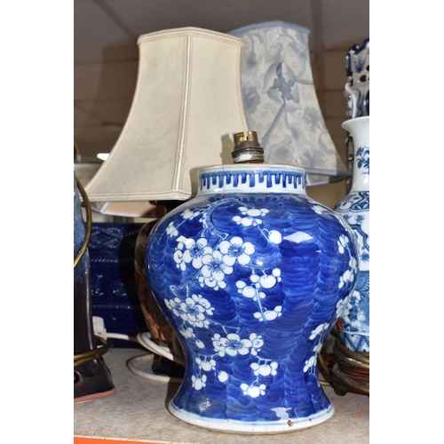 395 - A COLLECTION OF TALL ITEMS AND LAMPS, to include a small oriental blue ceramic table lamp, pattern b... 