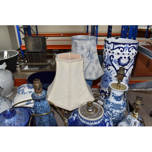 395 - A COLLECTION OF TALL ITEMS AND LAMPS, to include a small oriental blue ceramic table lamp, pattern b... 